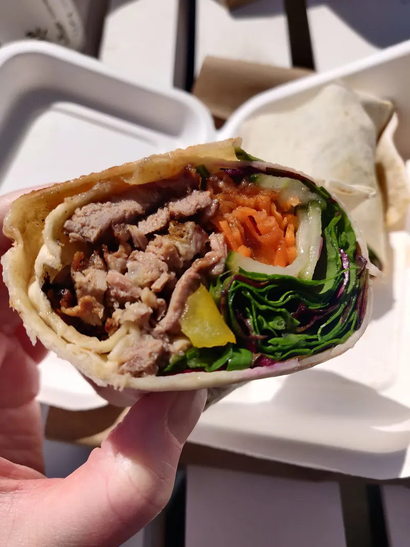 Fresh wrap with meat and vegetables in compostable packaging